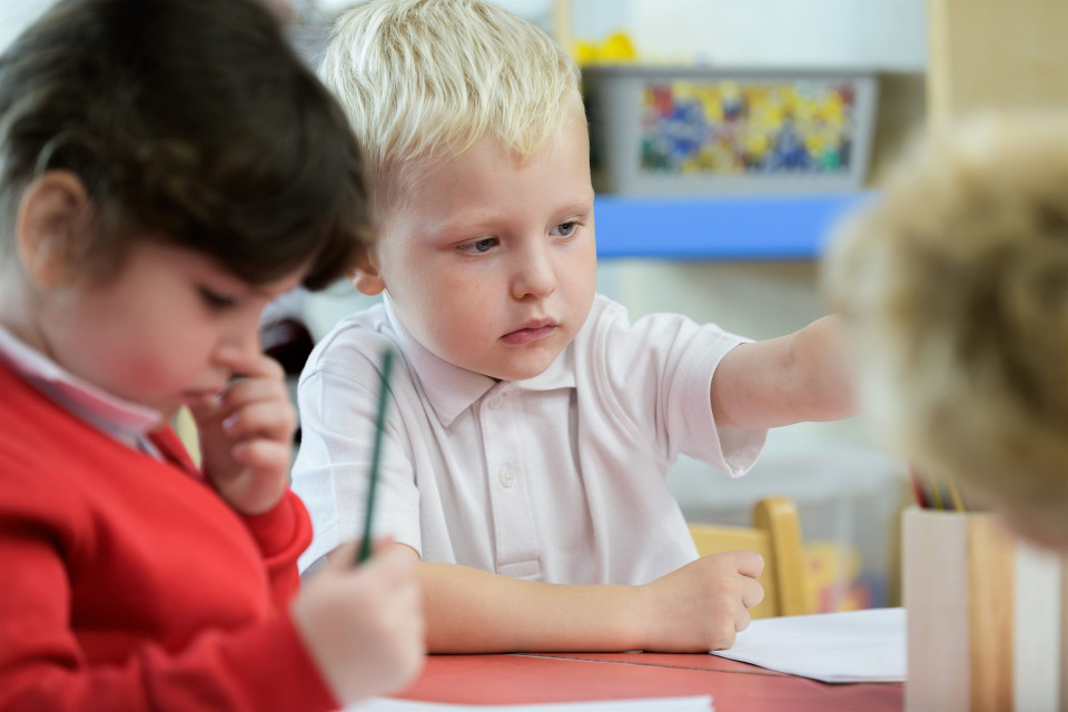 Young children concentrating on their drawings