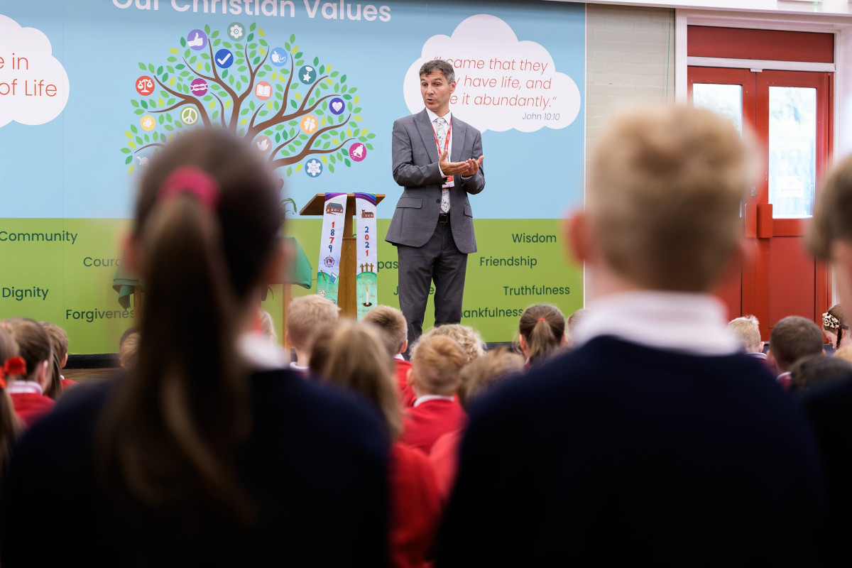 Children gathered for collective worship in the school hall
