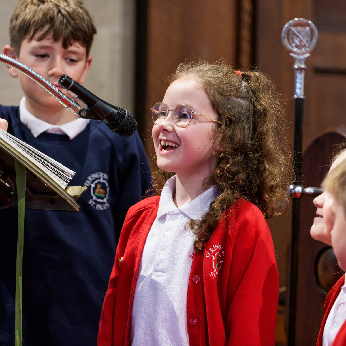Children laughing together during a visit to church