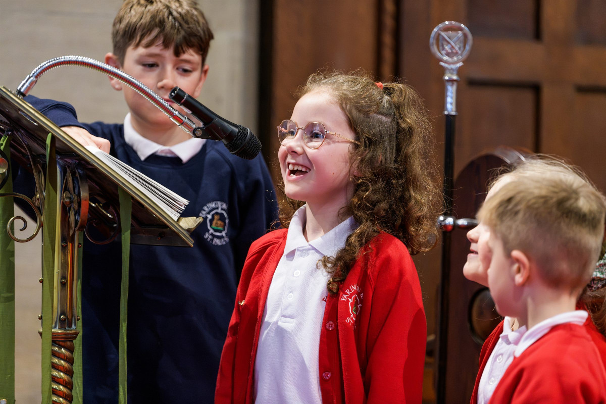 Children laughing together during a visit to church