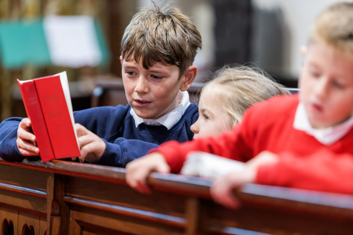 Children reading together in church