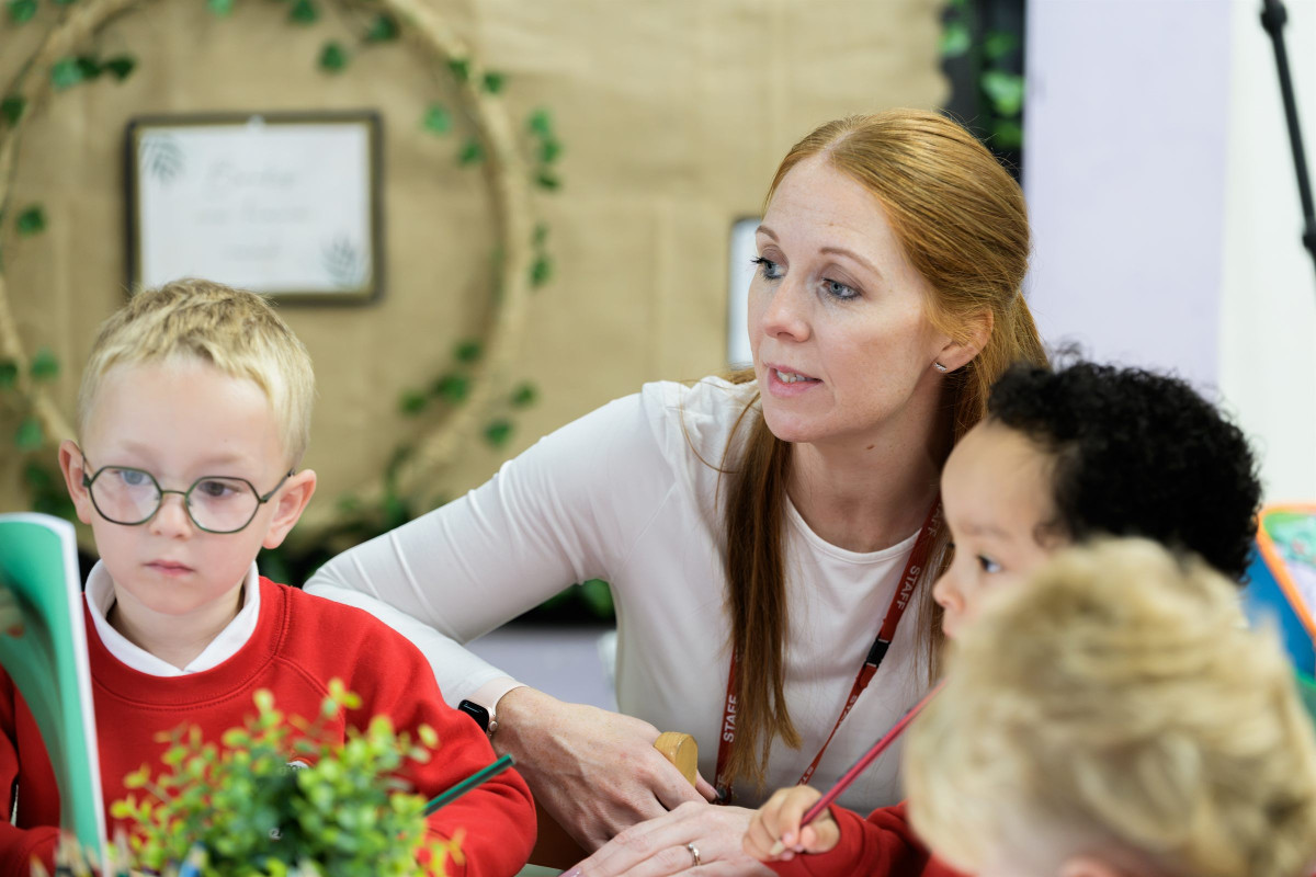 A teacher working with a small group of children